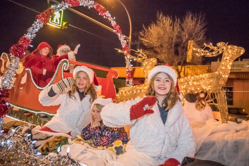 Osoyoos Royalty Princesses Amara Leeson (left) and Ali Hutter wave to parade watchers while in the background Santa and Mrs. Claus wave from their sleigh. Riding with the two princesses is little buddy Kaitlyn Hillson. (Richard McGuire photo)