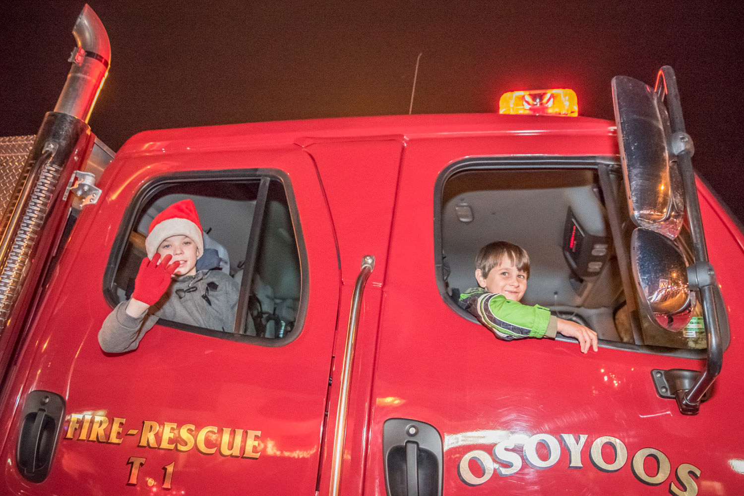 Children ride in the Osoyoos Fire Department truck at the back of the parade. (Richard McGuire photo)