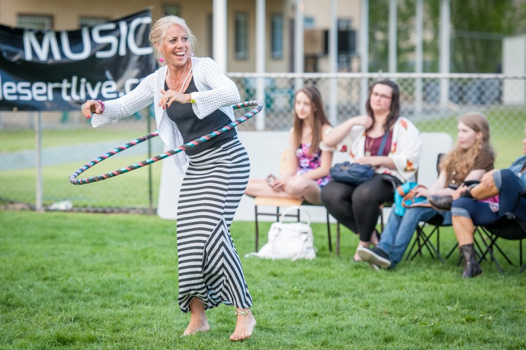 Teresa Carroll of Kamloops dances with a hula hoop while listening to music at Desert Live on Saturday evening. (Richard McGuire photo)