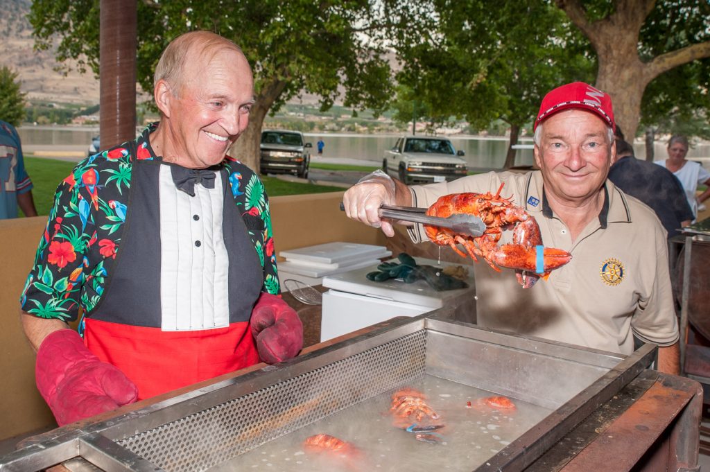 Rotarians Harold Cox (left) and Roger Clinton were busy cooking lobsters at the Rotary Club of Osoyoos' Lobster on the Beach fundraiser on Saturday evening. Guests dined in a huge tent at Gyro Park and the event was sold out with a waiting list. (Richard McGuire photo)