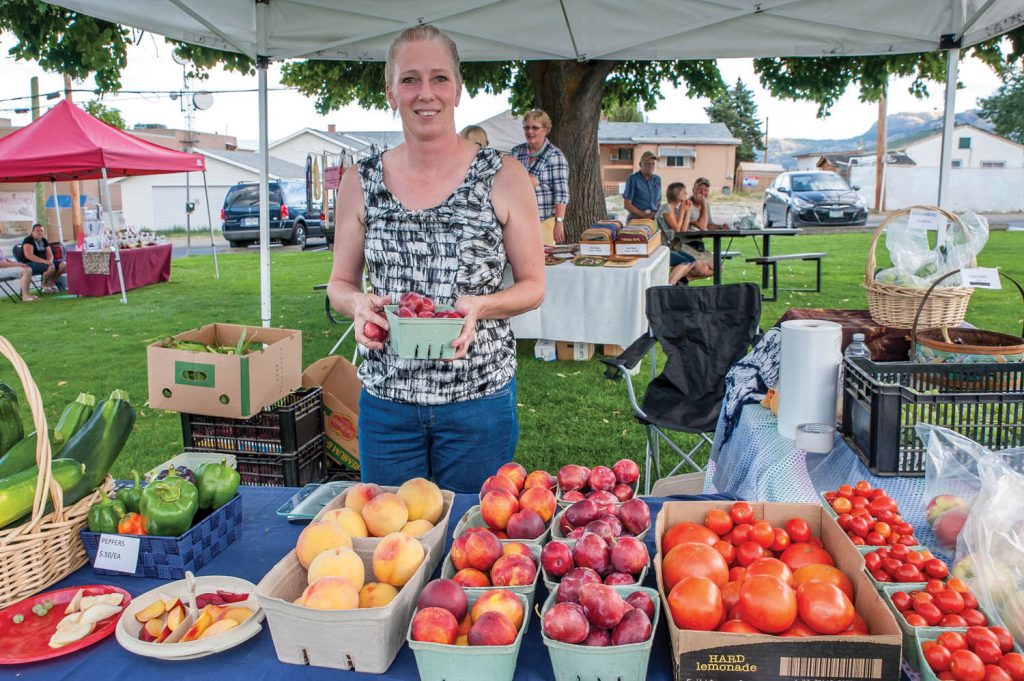 Wanda Pendergraft was selling fresh fruit and vegetables at a Wednesday evening market last August. It’s still a bit early for local produce, but when Market on Main opens this Saturday there will be locally made crafts, entertainment and possibly wine and bedding plants. (Richard McGuire file photo)