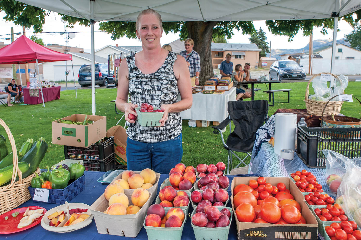 TO MARKET - Matt Nickson of Farfle Fresh Farms shows off the homegrown goods during the Thursday Evening Market, which is held every week between 4:30 and 8 p.m. at Oliver Community Park. Check out Thursday’s market to see what local growers and artisans are offering. (Dan Walton photo)