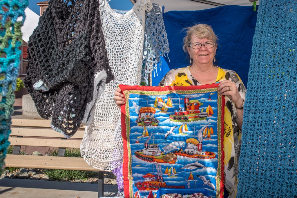 Market on Main opened for the season on Saturday. While it's too early from fresh fruit and vegetables, there were vendors selling crafts, preserves and other items. Pictured here Jan Kenney of Osoyoos shows off some of her crochet and sewing work that she does entirely without machines. (Richard McGuire photo)