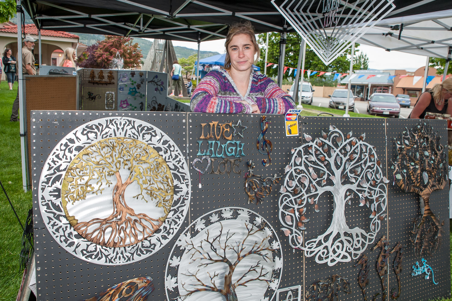 Cristal Macor of Humdinger Designs was at the opening of Market on Main selling decorated metal designs that she makes with her husband Stephen. Before fruit and vegetables arrive, crafts dominate the market. (Richard McGuire photo)