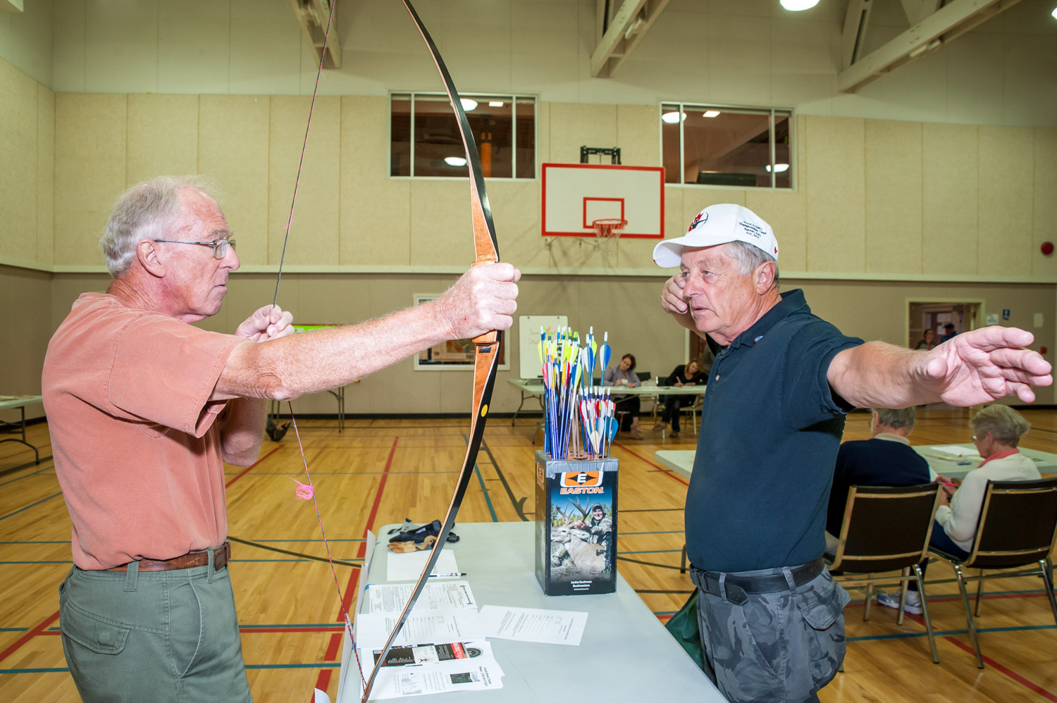 Osoyoos resident Bob Stubbs (left) checks out a bow while talking to Brock Paton, coach and founder of the Osoyoos Traditional Archery School. The two were at last Wednesday's mass registration event at the Sonora Community Centre when clubs and organizations recruited new members and volunteers while discussing what their groups do. (Richard McGuire photo)