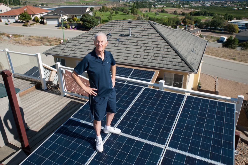 Paul McCavour shows off some of the 24 solar panels above his house that provide electricity to his home. (Richard McGuire photo)