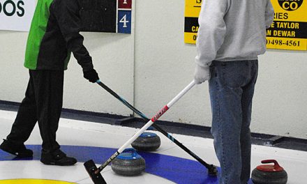 Discussion time on the ice at the Oliver Curling Club