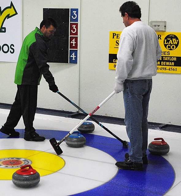 Discussion time on the ice at the Oliver Curling Club