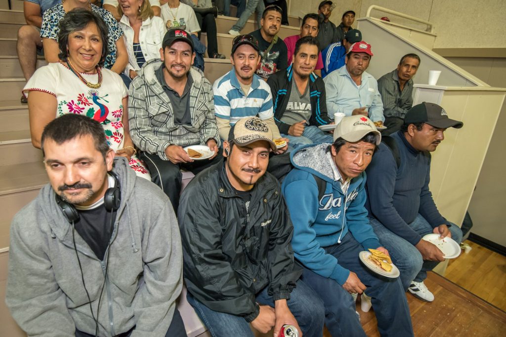 Osoyoos resident Sonia Lopez (left at back), originally from Mexico, sat with some of the Mexican workers who come from all parts of Mexico. In front left is Lorenzo Montoya, from Guadalajara, who is spending his fourth season working in Osoyoos. Others to his right are from places such as Puebla and Mexico City. (Richard McGuire photo)