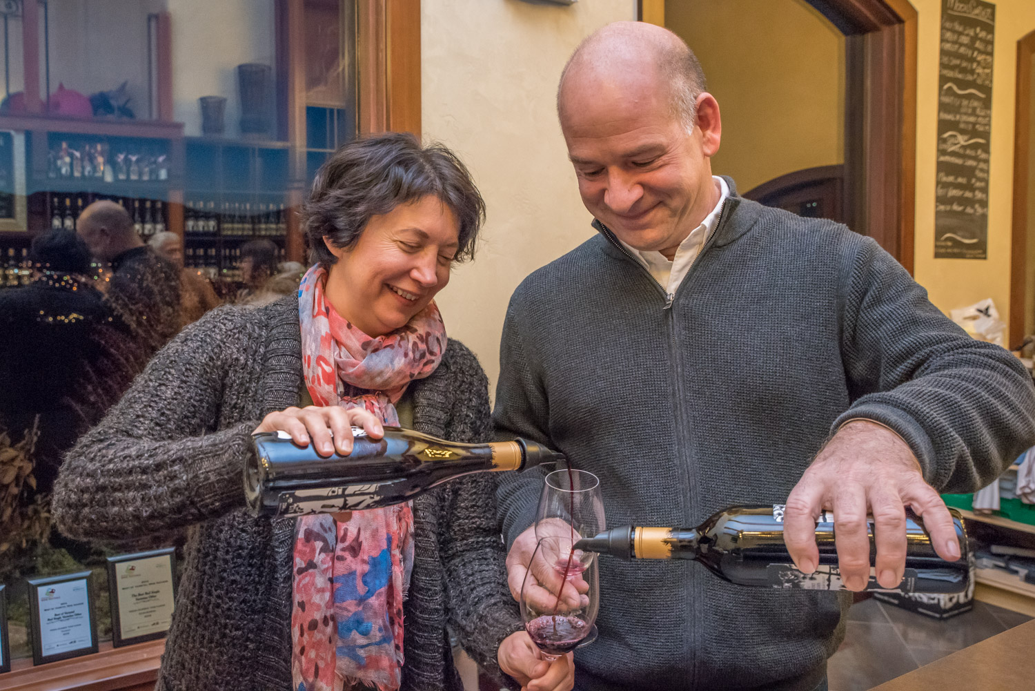 Winery owners Beata and Chris Tolley pour each other a glass of wine at Moon Curser Vineyards' open house last Friday. Guests sampled some of the varieties the winery makes. With the weather co-operating this year, it's been an exceptionally good year for local wineries. (Richard McGuire photo)