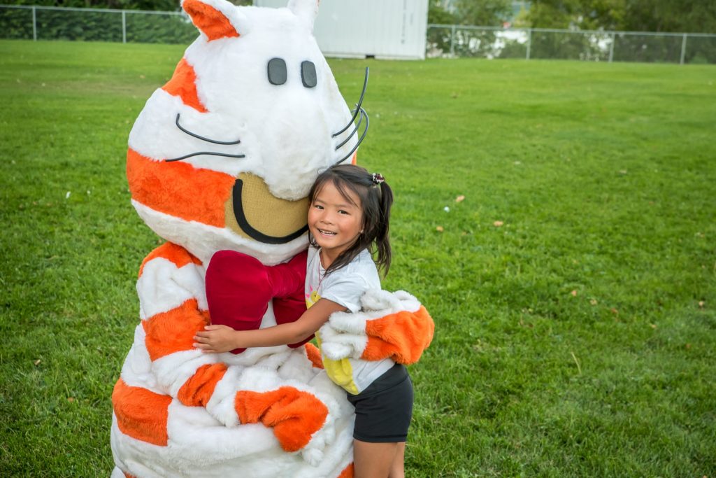 Kelsey Lao, 6, had a big hug for a furry feline who was several times her size. She was at the upper playground at Osoyoos Elementary School Monday evening for a showing of the film Zootopia at Interior Savings Moonlight Movie Night. The event was held in co-operation with the Rotary Club of Osoyoos, who received all proceeds. The Rotary Club carries out community projects in Osoyoos and elsewhere. There were games for children before the movie got underway at nightfall. (Richard McGuire photo)