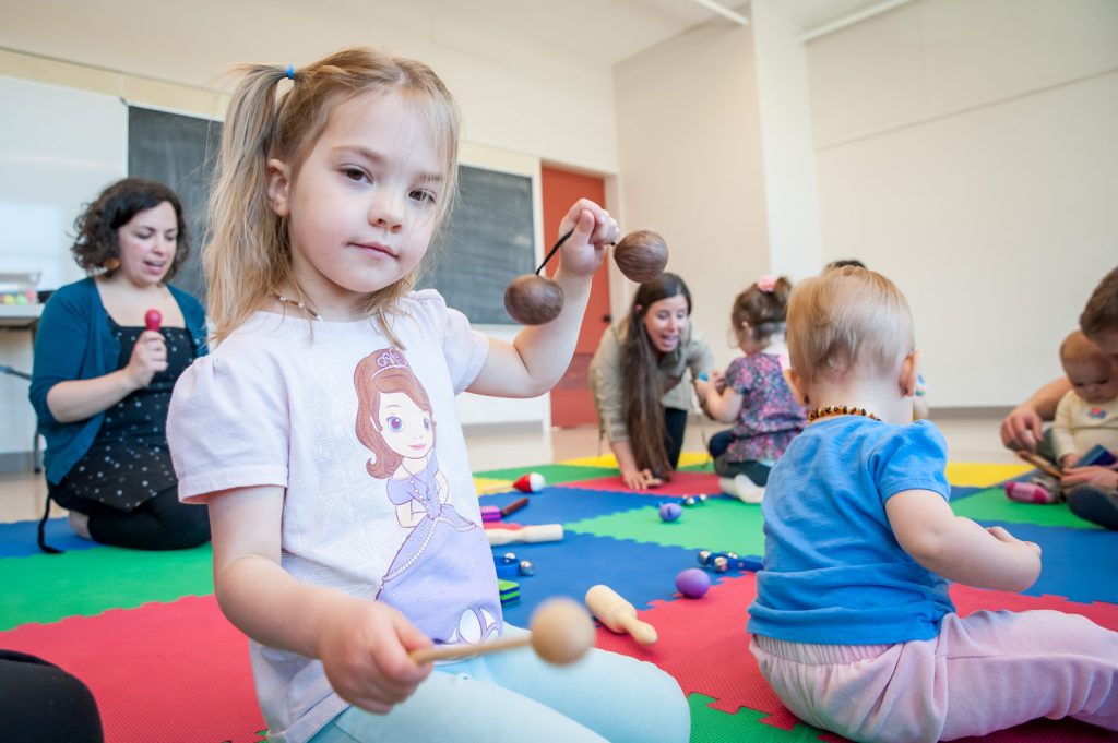 Makenzie Lockerby beats out a rhythm in the Little Tree Music Together program, taught by Maiya Robbie, which exposes children aged five and younger to music. The program runs Fridays at the Sonora Community Centre. (Richard McGuire photo)