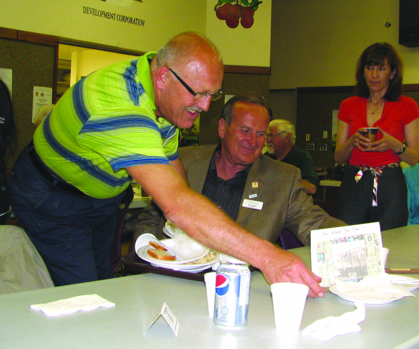 oibdinnerweb Roughly 100 people from Osoyoos Indian Band and the towns of Osoyoos and Oliver gathered in Oliver on May 26 to recognize the National Day of Healing and Reconciliation. Pictured is Coun. Ted Cronmiller clearing away Mayor Stu Wells’ dinner plate. Councillors from Osoyoos and Oliver served dinner at the gathering. Photo by Karen Knelsen