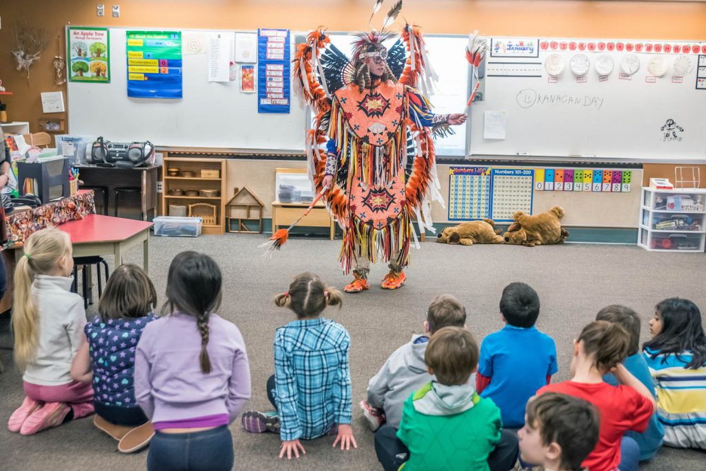 Children at Osoyoos Elementary School were exposed to the culture of the Okanagan people last Friday for the school's Okanagan Day. They rotated around different classrooms to learn about different aspects of Okanagan culture. Pictured here, Caine Kruger talks about pow wows and dance as he wears regalia borrowed from the Nk'Mip Desert Cultural Centre. (Richard McGuire photo)