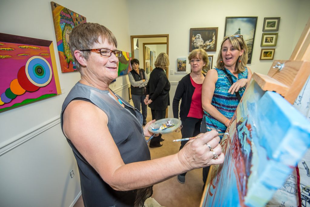 Osoyoos artist Sandra Albo was one of three local artists doing a "paint off" Friday at the official opening of the Okanagan Art Gallery in Osoyoos. The artists had just one hour to complete a painting, which was auctioned off afterwards. (Richard McGuire photo)