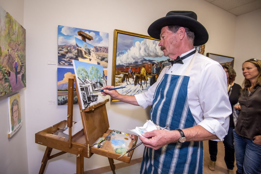 Osoyoos artist Michael Jorden was one of three local artists doing a "paint off" Friday at the official opening of the Okanagan Art Gallery in Osoyoos. The artists had just one hour to complete a painting, which was auctioned off afterwards. (Richard McGuire photo)