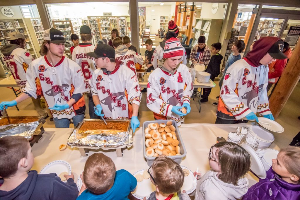 Members of the Osoyoos Coyotes served lunch to Osoyoos Elementary School students last Thursday at the conclusion of 21 Days of Kindness. From left are Evan Della-Paolera, Austin Cleaver, Jackson Glimpel and Adam Jones, while more team members are behind them. The lunch was donated by Watermark Beach Resort. During 21 Days of Kindness, students and staff draw attention to good deeds and acts of kindness in the hopes that the behaviour practised over the 21 days will be habit forming. (Richard McGuire photo)