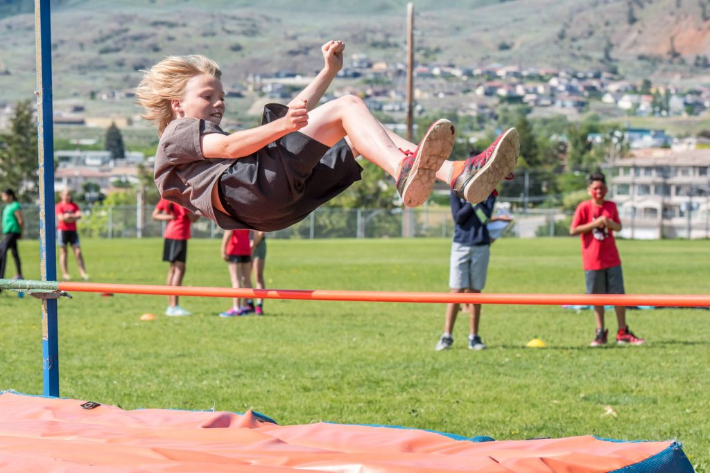 Jase Wright high jumps over the pole at Osoyoos Elementary School's track and field day. (Richard McGuire photo)