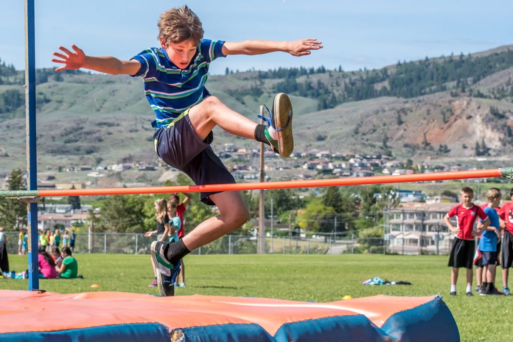 Jeremy Collier high jumps over the pole at Osoyoos Elementary School's track and field day. (Richard McGuire photo)