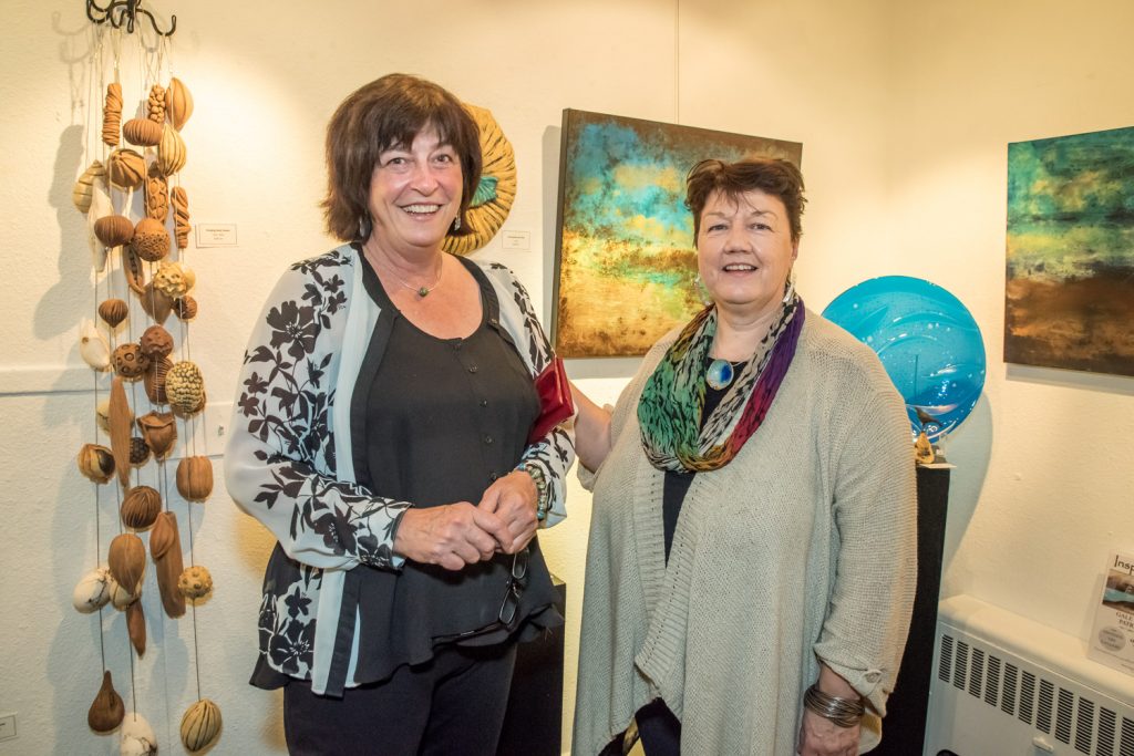 Vernon artists Patricia Doyle (left) and Gale Woodhouse attended the opening reception for their exhibition, Inspired Naturally, on Saturday evening at the Osoyoos Art Gallery. Doyle works with glass and Woodhouse is a potter and both women paint with acrylics. The exhibition runs until Nov. 7. (Richard McGuire photo)