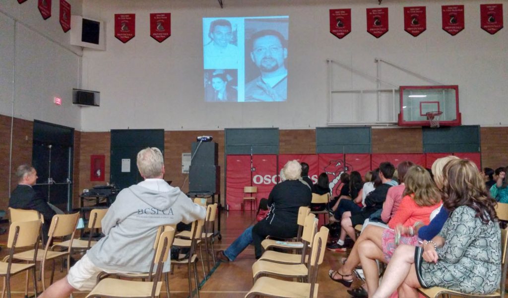 Guests watch a slide show of moments from the past at Osoyoos Secondary School during a celebration of the school's 37 years held Thursday evening. (Keith Lacey photo)