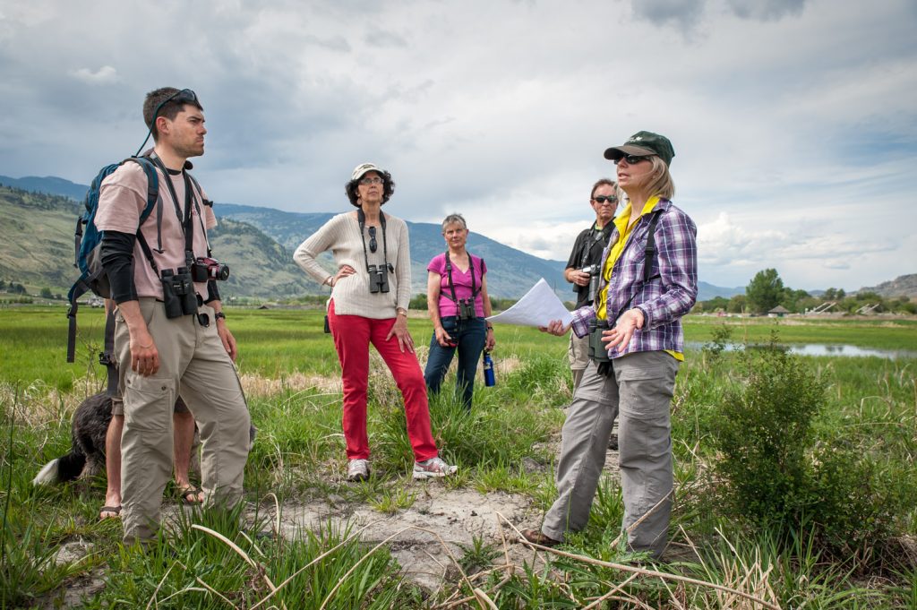 Barb Pryce, Southern Interior program manager with the Nature Conservancy of Canada, (right) shows a group of nature lovers the work that was done to restore the Osoyoos Oxbows. The tour followed the official opening of new information panels at the kiosk Friday. The oxbows themselves were restored over a year ago in a joint project between the NCC and Ducks Unlimited. (Richard McGuire photo)