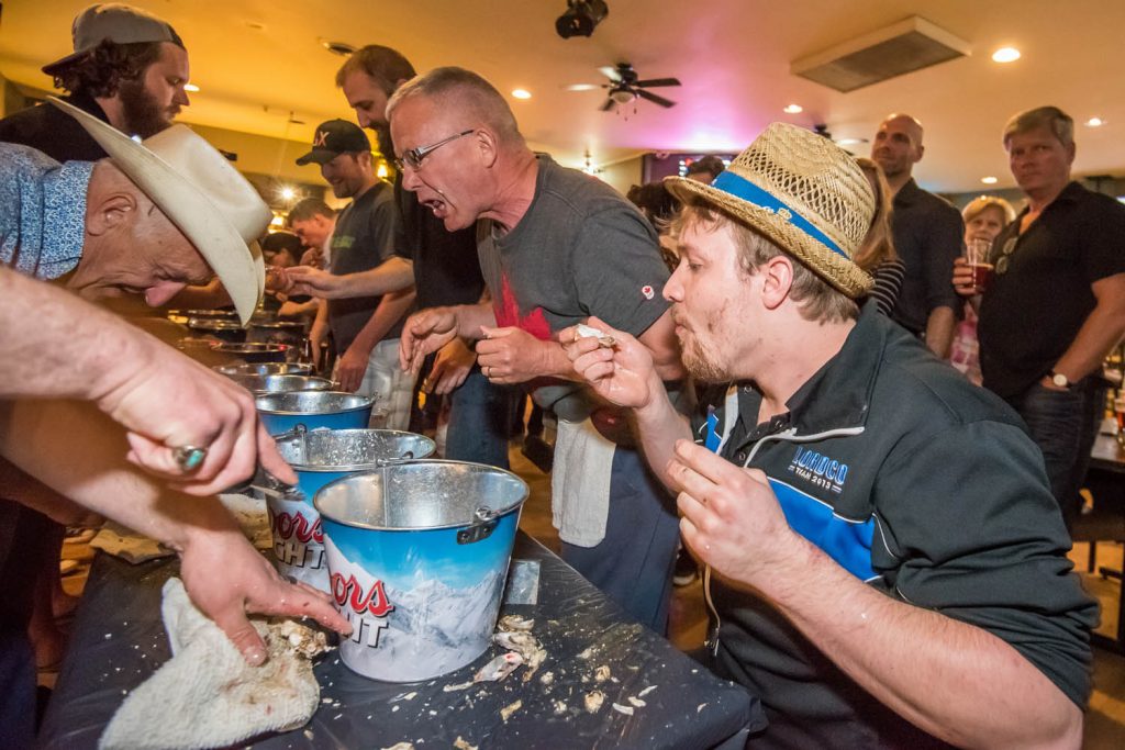 Aaron Zandvliet (right) sucked back oysters to win the Sage Pub's fifth annual Shuck 'n Suck competition in April. His partner, Andrew Cook, quickly shucked them. The race involved teams of two with one person shucking oysters and the other person sucking them back. Zandvliet and Cook were the defending champions. This was Zandvliet's second year and Cook's third year as a champion. This fun event contrasted with some of the more classy events taking place during the Osoyoos Oyster Festival at resort hotels and wineries. (Richard McGuire photo)