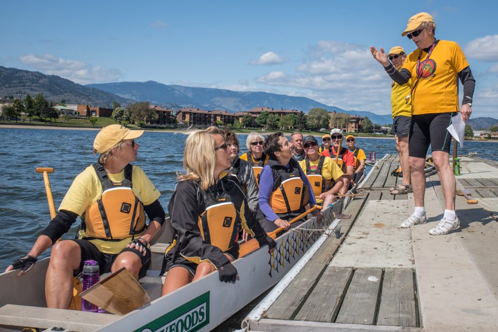 New recruits are given a lesson on how to get in and out of a dragonboat at an open house and introduction held Saturday by the Osoyoos Lake Paddling Club. (Richard McGuire photo)