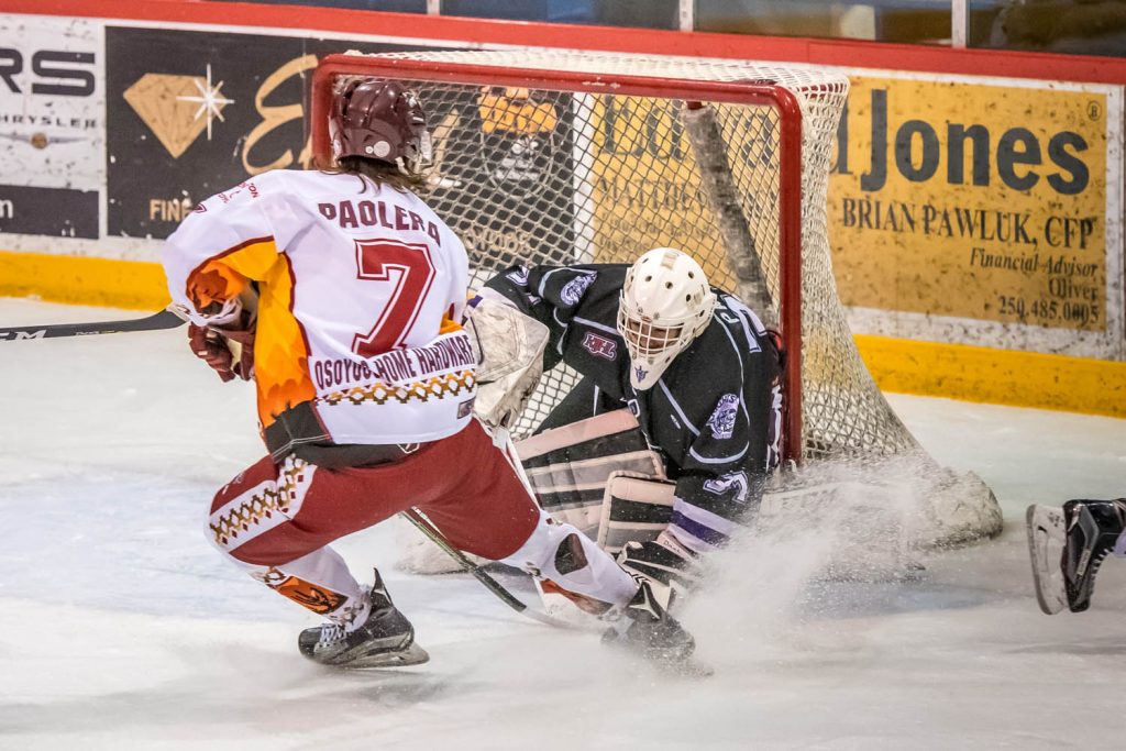 Evan Della-Paolera swoops in on North Okanagan goalie Daniel Paul. (Richard McGuire photo)