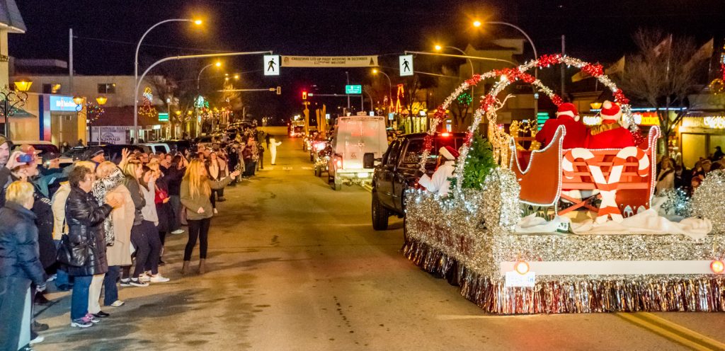 Spectators watch as the Osoyoos Royalty and Santa and Mrs. Claus ride by on the Osoyoos Festival Society's float in the Christmas Lite-Up parade. (Richard McGuire photo)