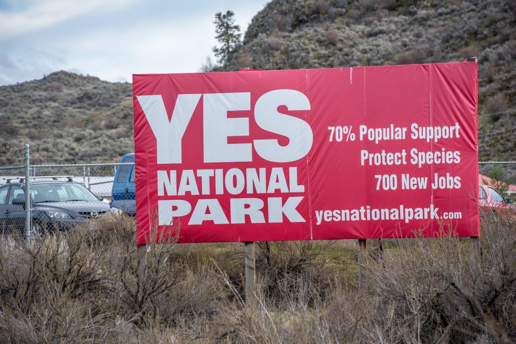After a pro-national-park billboard near Cawston was vandalized, the South Okanagan Similkameen National Park Network had the skin repaired and they relocated it to a safer location next to the Osoyoos industrial park. The SOSNPN plans to make the national park an election issue. (Richard McGuire photo)