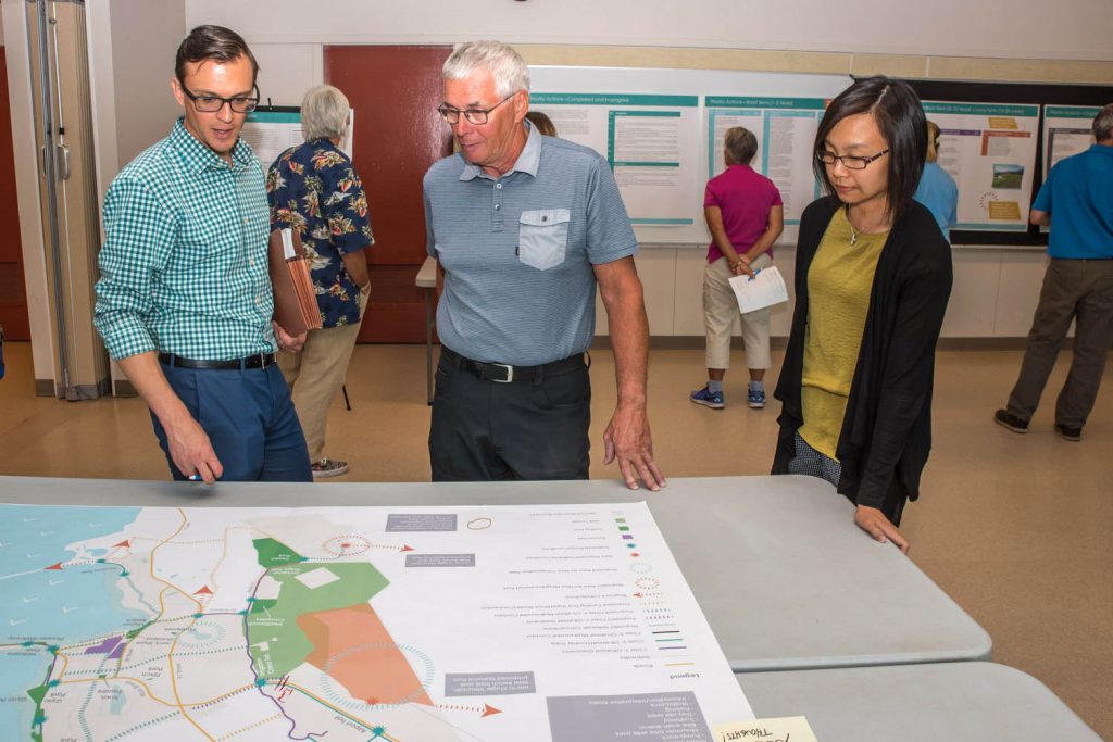Nalon Smith (left), of Stantec Consulting, talks with local resident Paul Daminato about the Parks and Trails Master Plan for Osoyoos. At right, Dilys Huang, senior planner with the Town of Osoyoos, looks on. (Richard McGuire photo)