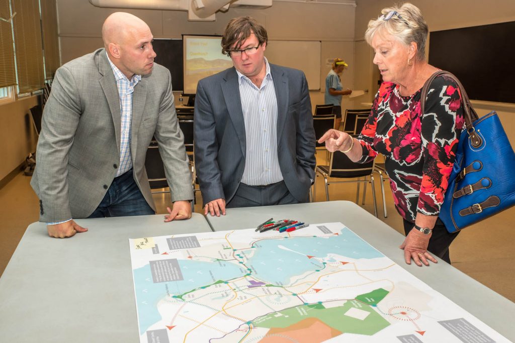 Justin Ellis (left) and Peter Truch, both of Stantec Consulting, discussed the Parks and Trails Master Plan at an open house in September with Mayor Sue McKortoff. (Richard McGuire photo)
