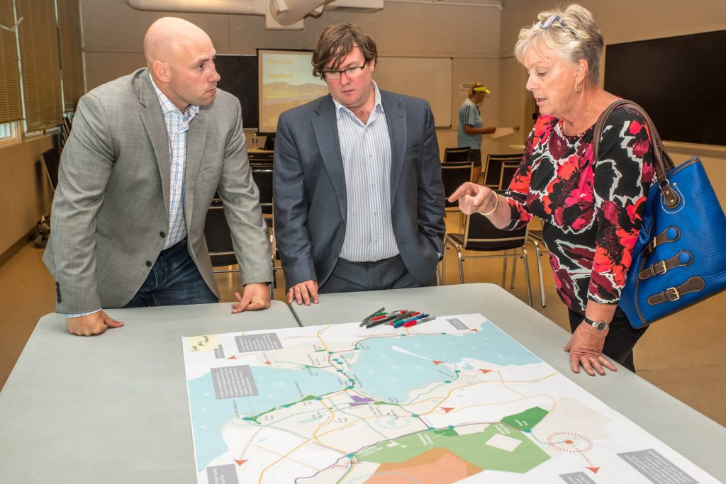 Justin Ellis (left) and Peter Truch, both of Stantec Consulting, discss the Parks and Trails Master Plan at an open house last Thursday with Mayor Sue McKortoff. (Richard McGuire photo)