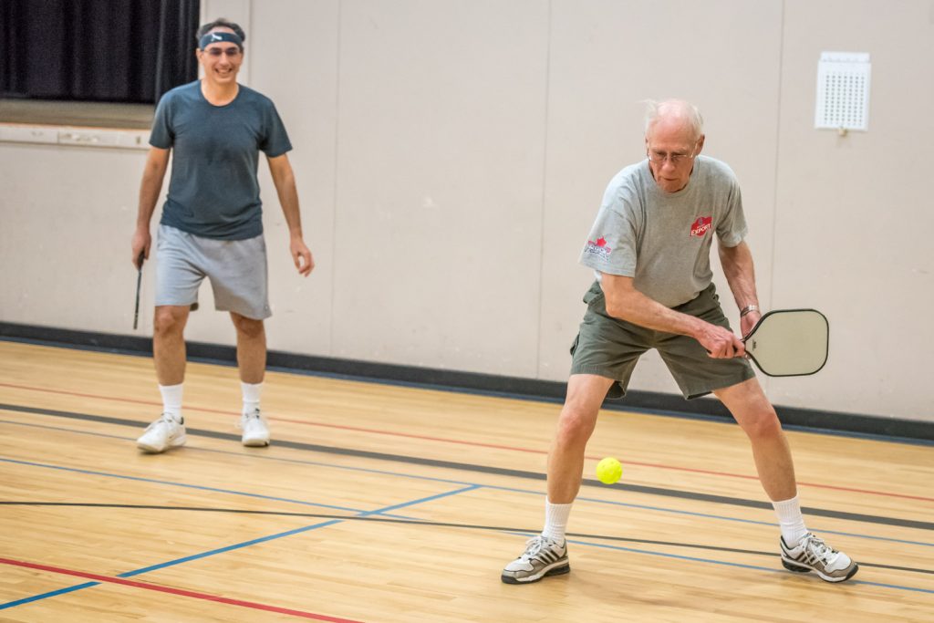 Michael Ryan swings for the ball while his partner Stephen Kushner looks on. This was Ryan's first time playing. The two were among those trying out pickleball on Friday at the Sonora Community Centre for Move for Health Day. Move for Health Day was started by the World Health Organization in 2002 to promote physical activity. The BC Recreation and Parks Association (BCRPA) promotes it with support from Healthy Families BC. (Richard McGuire photo)