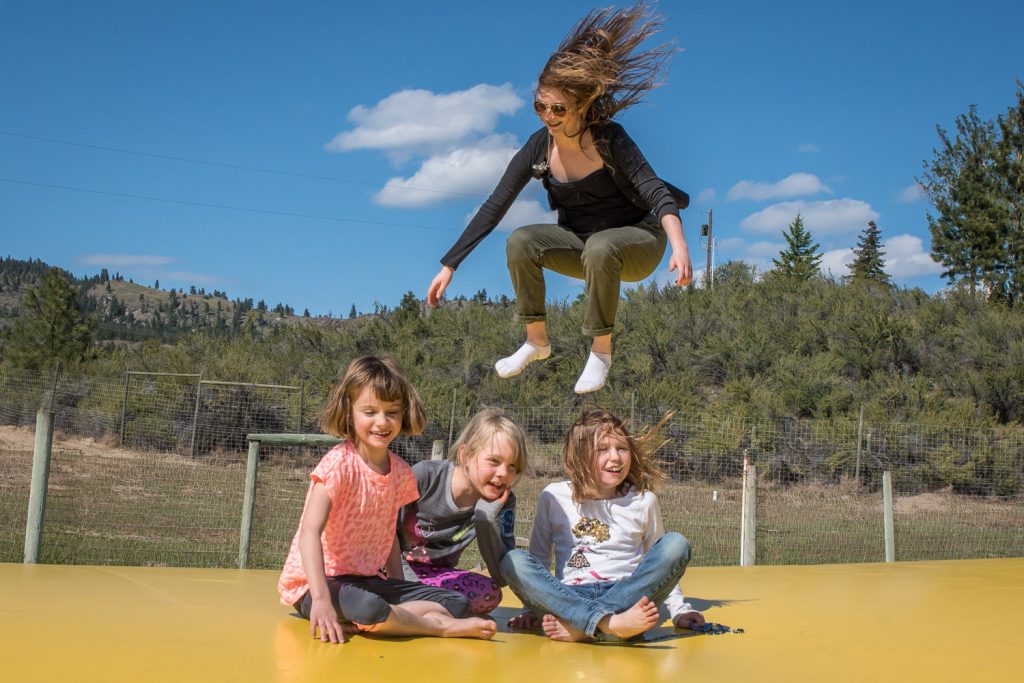 Sarah Cartwright takes a leap above Jennifer Vallee, Avanda Looper and Caitlin Keeler on the Jumping Pillow at Pig Out of Saturday at Covert Farms. This was a popular spot for children of all ages while adults sampled fine food and wine. (Richard McGuire photo)