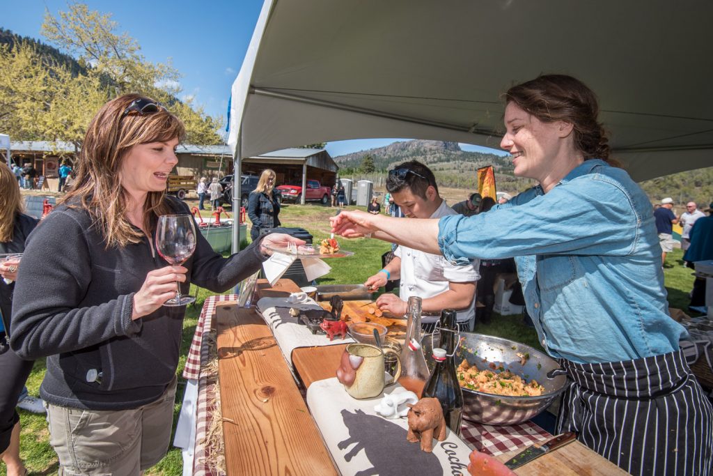 Dana Ewart (right) of Joy Road Catering serves a guest with delicious food at Pig Out held on Saturday at Covert Farms north of Oliver. Guests had a chance to pair local wines with food prepared by some of the area's best chefs. (Richard McGuire photo)