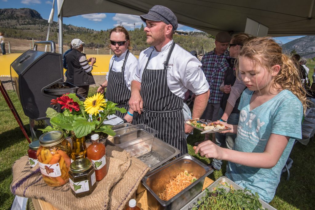 From left Damian Mischkinis, Lee Humphries and Chelsea Keeler were serving fine food at the Sonora Room's booth at Pig Out on Saturday. The Sonora Room is located at Burrowing Owl Estate Winery. Pig Out was held at Covert Farms and allowed guests to pair wine from local wineries with food prepared by some of the area's best chefs. (Richard McGuire photo)