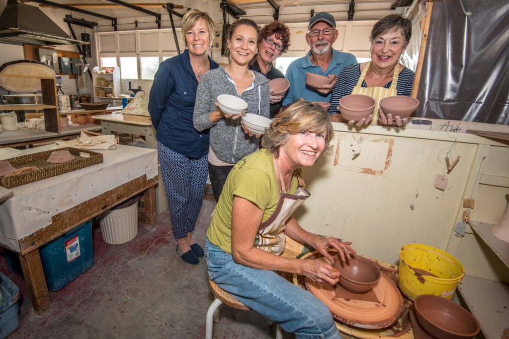 Members of the Osoyoos Potters Club are busy making bowls for Desert Sun Counselling and Resource Centre's Empty Bowls Fundraiser. In the front, Darlene Fillion spins a bowl on a potters wheel. Behind are Sandy Summers, the Desert Sun board member chairing the event (left), and potters Megan Byblow, Dianne Hughes, Jim French and Sheila French. The fundraiser will replace the Grand Night, which has been used over the past decade to raise money for Desert Sun. (Richard McGuire photo)