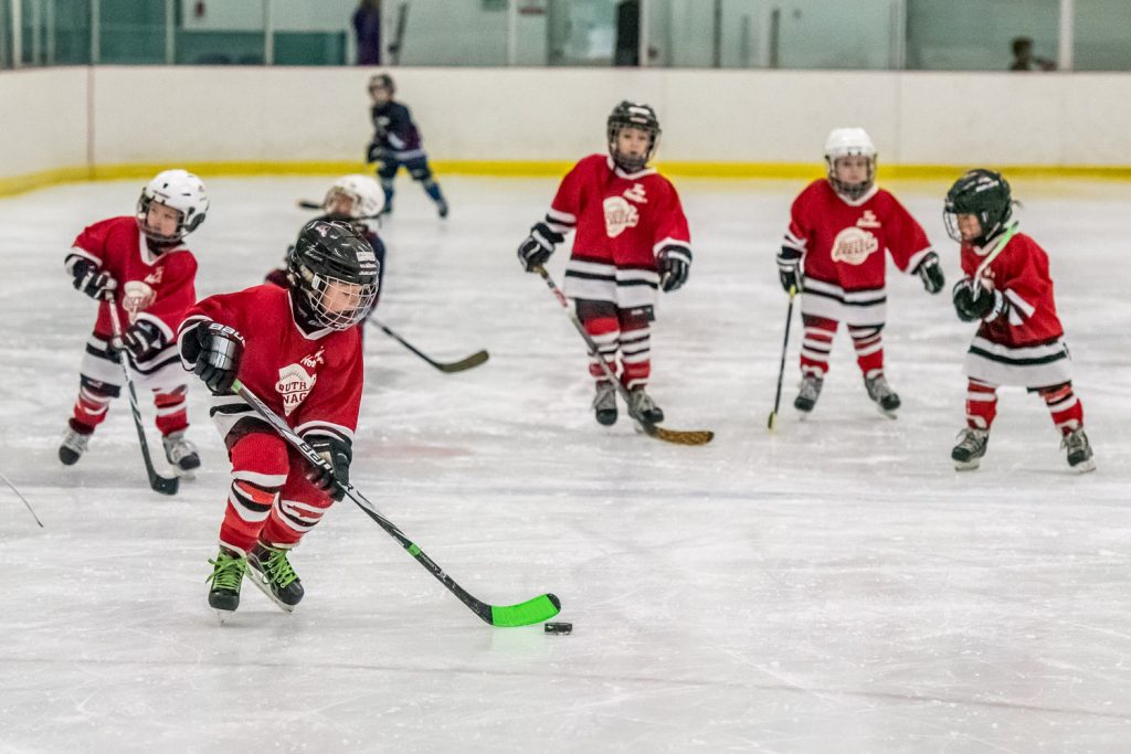 There's safety in numbers as the South Okanagan Red Dragons advance from their end in the Hockey Wars Pre-Novice Tournament at the Oliver Arena on Saturday. In this game the local team faced the West Kelowna Sharks. Six teams participated in the tournament that included children as young as four. The tourney was organized by the South Okanagan Minor Hockey Association. (Richard McGuire photo)