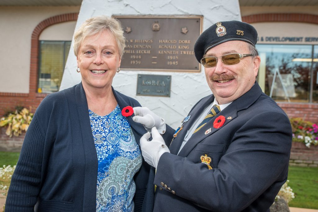 Bruce Davies, president of the Royal Canadian Legion Branch 173, pins a poppy on the lapel of Mayor Sue McKortoff to mark Remembrance Week, which runs from Nov. 5 - 11. Mayor McKortoff issued a proclamation declaring Remembrance Week in Osoyoos to honour, salute and express gratitude to courageous veterans for their bravery and heroic actions in the face of danger and to pay tribute to and remember those who served in battle and peacekeeping. (Richard McGuiire photo)