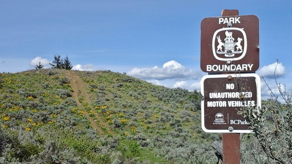 A sign in the present provincial park advises that motor vehicles are prohibited, but tire tracks across the sagebrush suggest this is ignored. NDP Critic Spencer Chandra Herbert says staff are never seen in the provincial park and as a result, the environment is degraded. A national park would offer better protection, he believes. (Photo supplied)