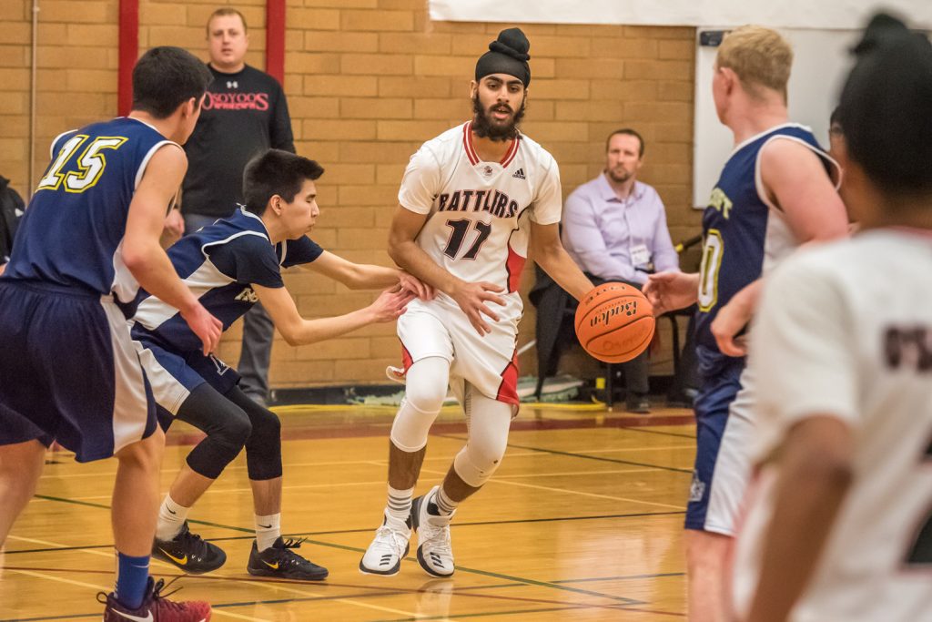 Kavneer Dhaliwal fends off players from all directions as he advances with the ball in the Rattlers' first game of the Valleys tournament. The Rattlers beat Ashcroft 76-32. (Richard McGuire photo)