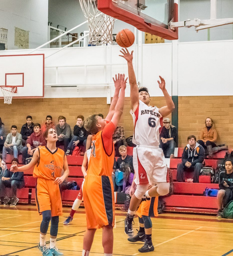 Benson Cheng of the Rattlers senior boys basketball team jumps to toss the ball at the net in Friday's game against Aberdeen Hall Preparatory School. The Osoyoos Secondary School team was down 12 points at one time, but came back from behind at the very end to win the game 73-66. This was the first game for the local team in the two-day Desert Classic tournament held at OSS. The Rattlers went on to win their second game by a convincing 69-45 over Heritage Christian School, before losing their final game by a single point,  80-79, to Kelowna Christian School. They still managed to pull off second place in the tournament. (Richard McGuire photo)