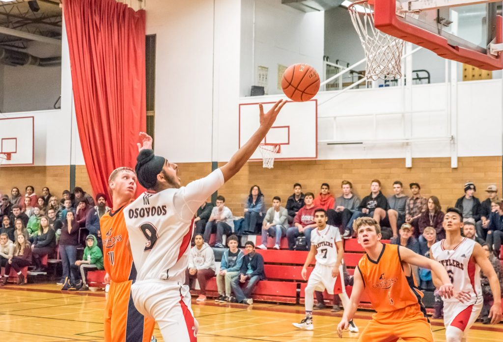 Gurlal Dhaliwal tries to score for the Rattlers as the Osoyoos Secondary School's senior boys basketball team came back from behind to beat Aberdeen Hall Preparatory School 73-66 Friday. This was the Rattlers' opening game in the two-day Desert Classic tournament. (Richard McGuire photo)