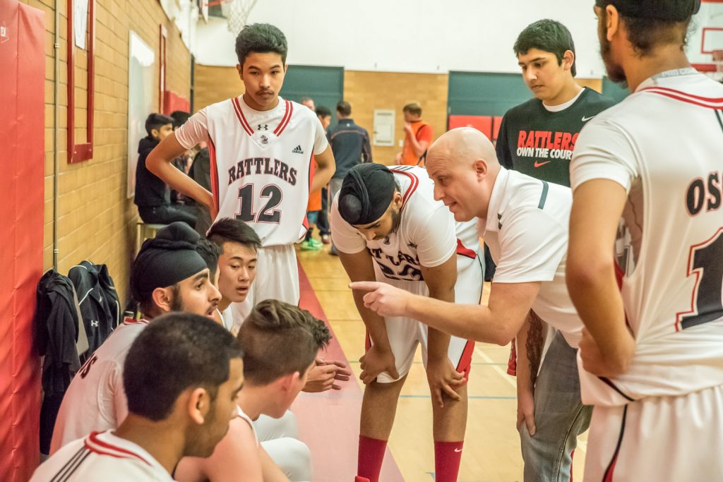 Rattlers Coach Casey Brouwer gives some final pointers during a time out in the final minutes of Friday's game against Aberdeen Hall Preparatory School. The Osoyoos Secondary School senior boys basketball team had been down 12 points, but at this point the two teams were virtually tied. Brouwser must have been successful in motivating the team -- they scored some points in the final minutes to win the game 73-66. (Richard McGuire photo)