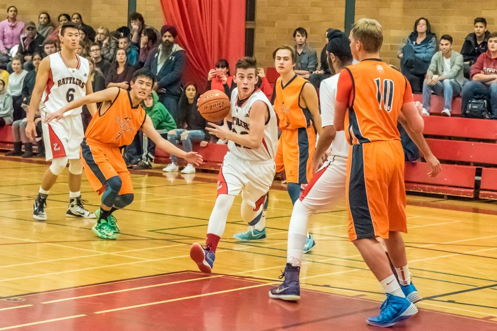 Justin Davis advances with the ball for the Rattlers as the Osoyoos Secondary School's senior boys basketball team came back from behind to beat Aberdeen Hall Preparatory School 73-66 Friday. This was the Rattlers' opening game in the two-day Desert Classic tournament. (Richard McGuire photo)