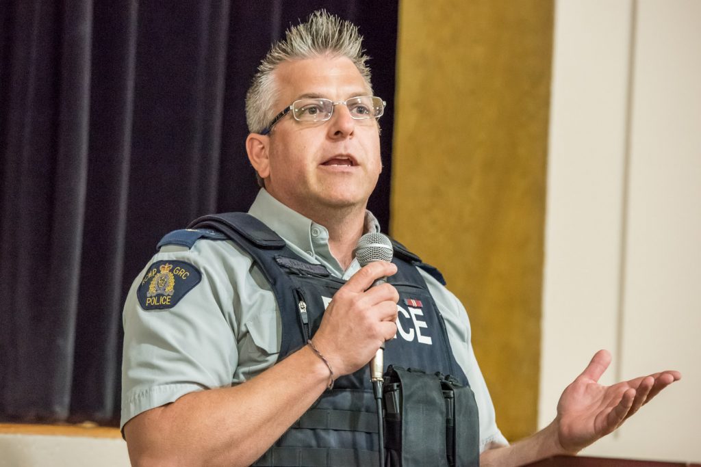Cpl. Jason Bayda, second in command at the Osoyoos RCMP Detachment, fielded many questions from the audience at the RCMP’s Community Safety Forum at the Sonora Community Centre last Thursday. Questions concerned such issues as traffic offences, a long-time drug dealer, need for 24-hour policing, desire to see the RCMP provide weekly reports to the media and need for information about fraud. Bayda, along with Sgt. Randy Bosch, and Supt. Kevin Hewco from Penticton, said police have limited resources and they must constantly prioritize what they work on. (Richard McGuire photo)
