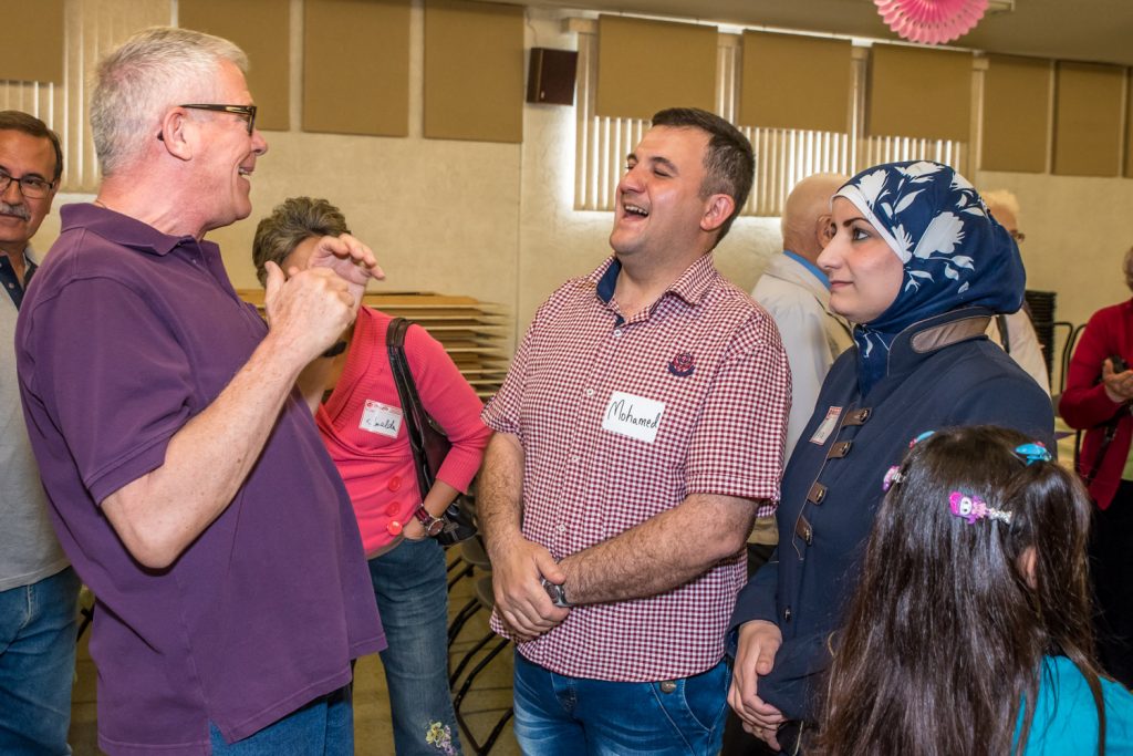 David Smith (left) shares a laugh with Mohamad and Aya. (Richard McGuire photo)
