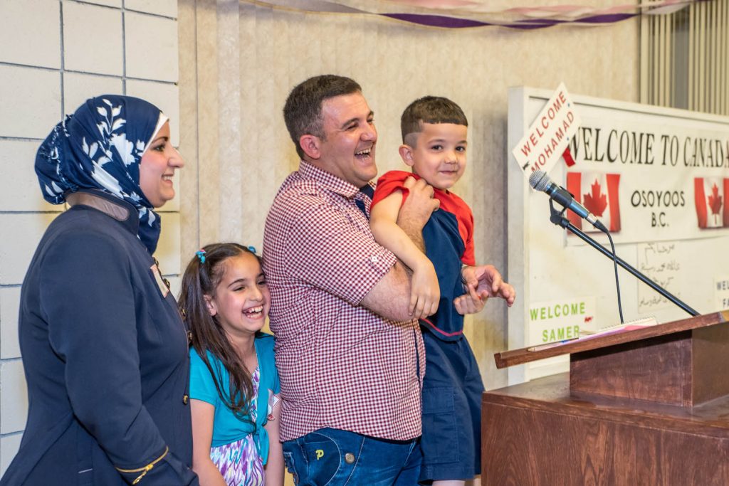 At a community event in April to welcome the Tabanjat family, refugees from Syria, the family got up to thank the Osoyoos community. Son Samer's enthusiastic "Thank you" into the microphone caused many people to laugh, including mother Aya, father Mohamad and sister Fatima. (Richard McGuire photo)